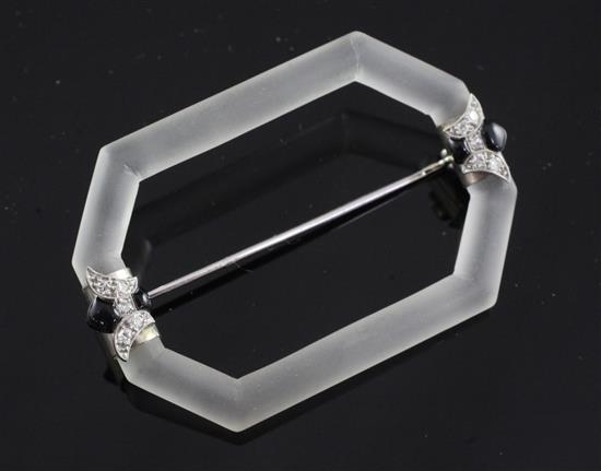 An Art Deco white gold, diamond and onyx mounted frosted glass brooch, 2in.